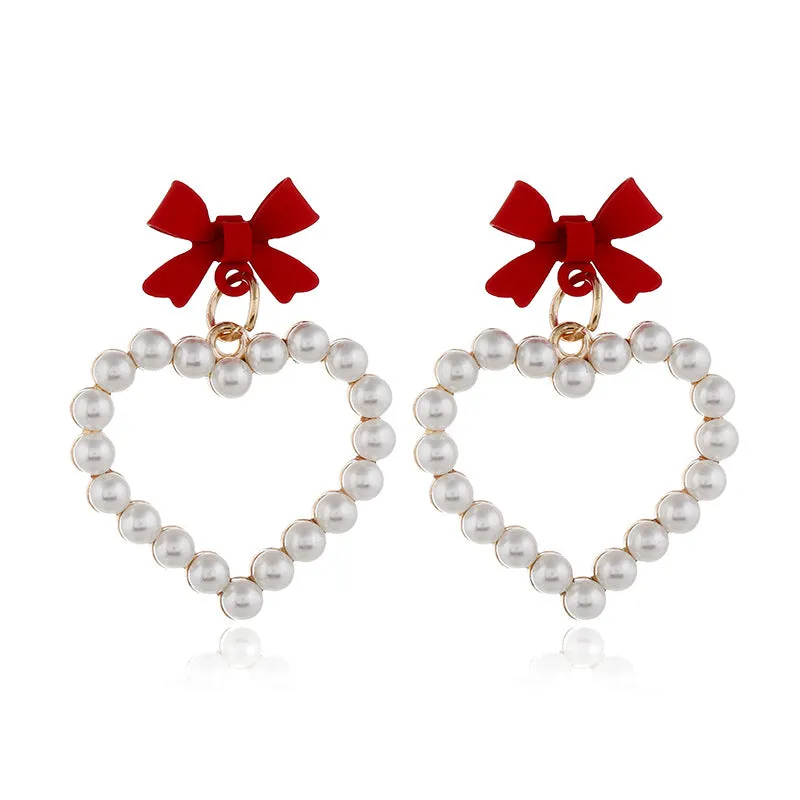 Wholesale Pearl Hollow Heart Shaped Pendant Bow Alloy Earrings
