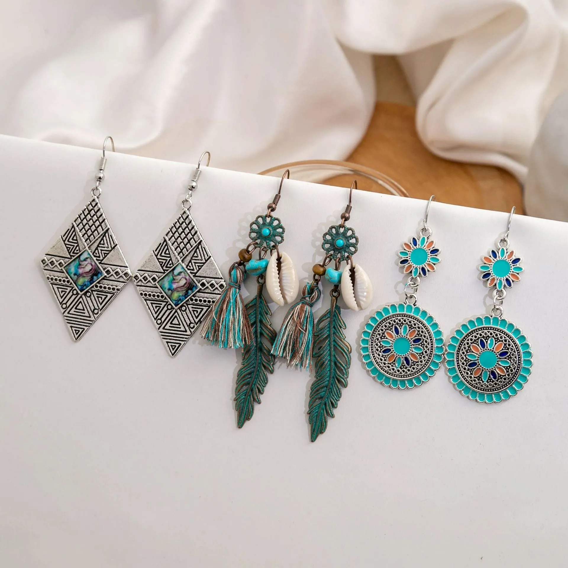 Wholesale Vintage Sunflower Feather Tassels Ethnic Style Round Hollow Alloy Earrings