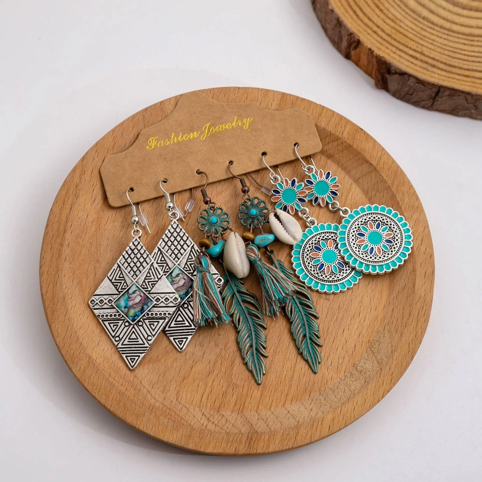 Wholesale Vintage Sunflower Feather Tassels Ethnic Style Round Hollow Alloy Earrings